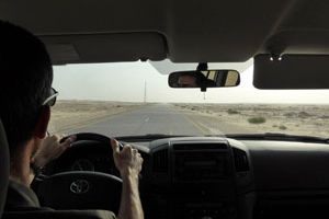 Tourist driving in the Omani central plain.
